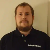 Hans-Erik-Drammen-e1599466850986-300x300 En mann med kort hår og skjegg, iført svart poloskjorte med "Låssenteret" skrevet på, står foran en helt vanlig vegg.